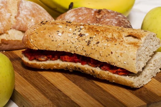 View of a dish of fresh sandwich with seeds filled with Portuguese chorizo.
