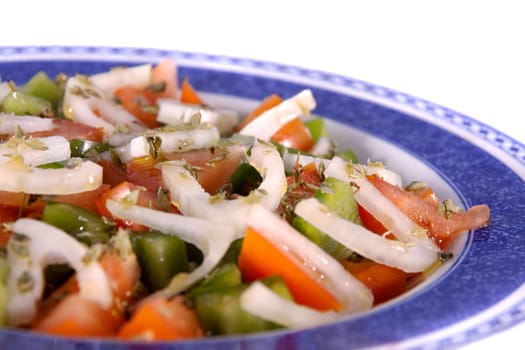 Detail view of a fresh made Mediterranean salad isolated on a white background.