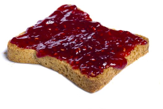 Close view of a toasted bread with berry jam spread  isolated on a white background.