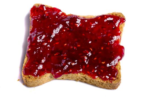 Close view of a toasted bread with berry jam spread  isolated on a white background.