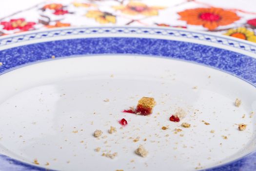 Close view of a dish with crumbs of toasted bread with jam.
