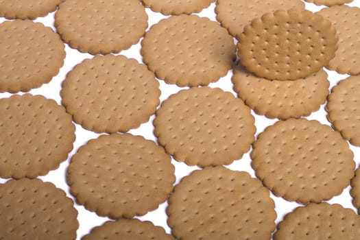 View of many round biscuits isolated on a white background.