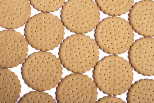View of many round biscuits isolated on a white background.