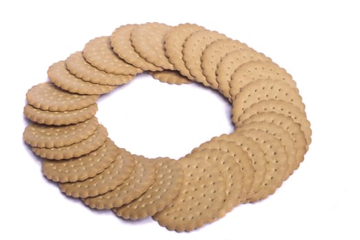 View of many round biscuits isolated on a white background.