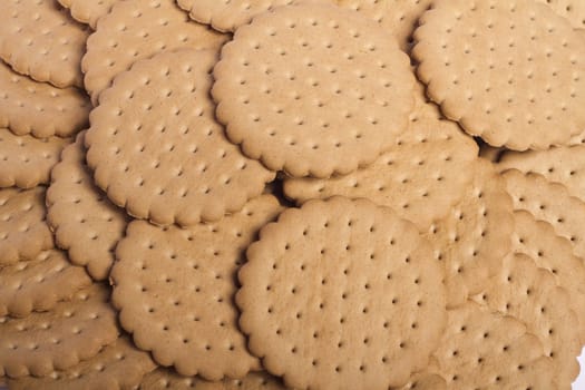 View of many round biscuits stacked on top of each other.