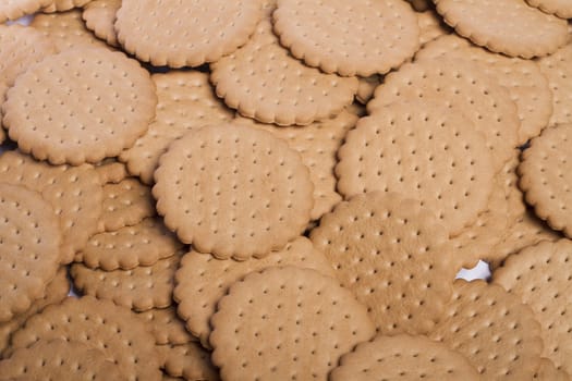 View of many round biscuits stacked on top of each other.