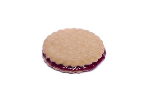 View of a round biscuit isolated on a white background with berry jam.