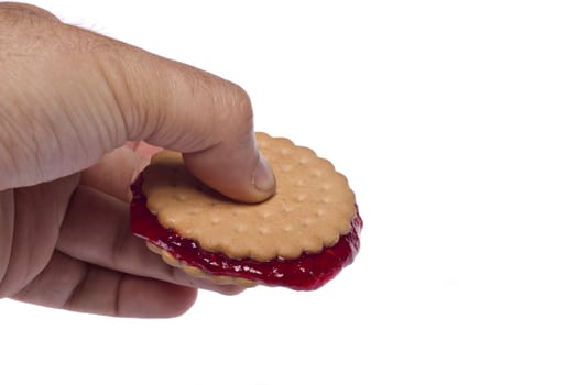 View of a round biscuit isolated on a white background with berry jam.