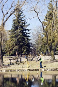 Surveying by the lake in residential area.