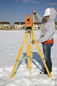 Measuring height of theodolite - winter time surveying.