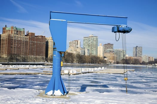 Boat Crane in frozen marina.