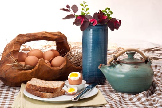 Beautiful breakfast table layout with boiled egg, toast and tea