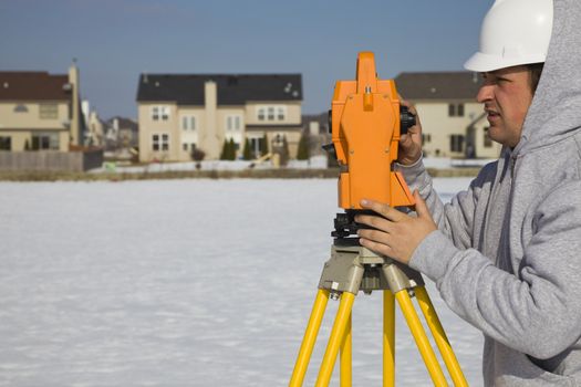 Land surveying during the winter - suburban area.