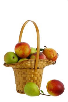 Fresh pears, peaches and nectarines in interwoven basket isolated on white background