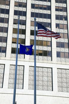 USA and Wisconsin flags against skyscraper in downtown of Milwaukee.