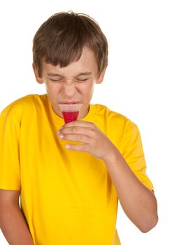 boy drinking medicine isolated on white