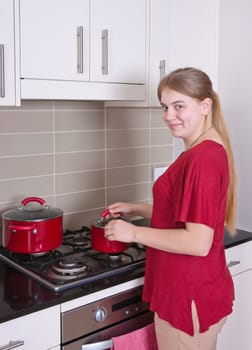 young woman is cooking in the kitchen