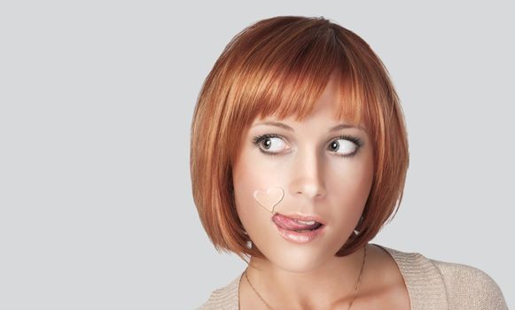 Beautiful red woman with heart shaped water drop on her face