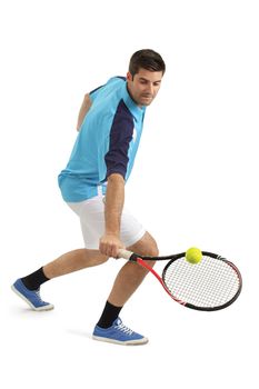 Photo of an attractive male tennis player hitting the tennis ball.