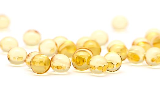 Transparent yellow capsules isolated on white