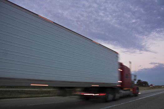 Semi Truck driving at sunset