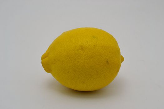 The single lemon over the white background