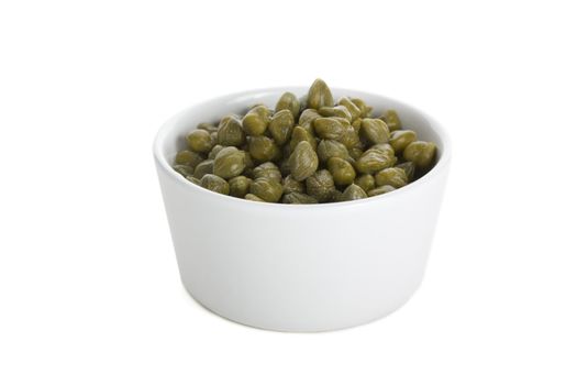 Small bowl of capers isolated on white background.