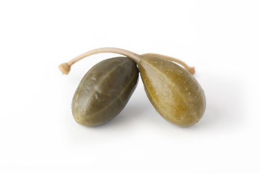 Two capers isolated on a white background.