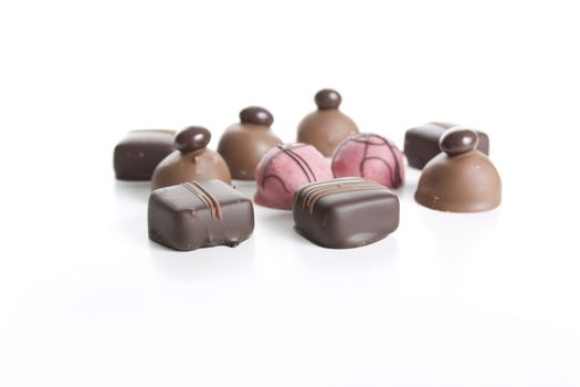 Ten gourmet chocolates isolated on a white background