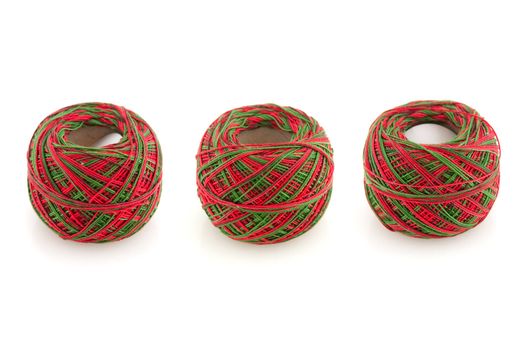 Three cotton spools isolated on a white background.
