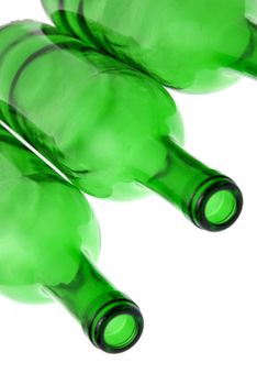 Detail of empty green glass wine bottles on white background.