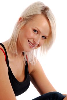 Blond girl sitting casually on white.