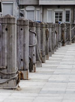 vertical portrait of quayside wharf berths bollards quays and public footpath, crop space and copy area