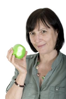 Balanced diet concept shot. Aged woman with fresh apple in her hand.