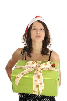 Pretty young woman holding christmas gift and sending kiss