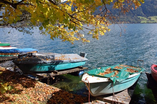 Boats covered with leafs on autumn in Zell am See, Austria