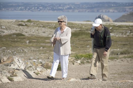 Senior couple walking along the coast of Brittany