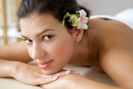 Close-up of young woman relaxing on massage table