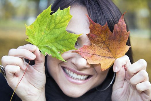 Pretty smile and colorful leaves - middle of the fall.