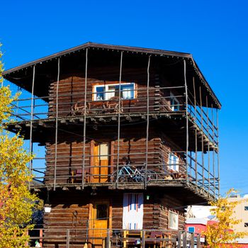 Famos three-story log skyscraper downtown Whitehorse, Yukon Territory, Canada, contrasting a nearby modern multi-story building