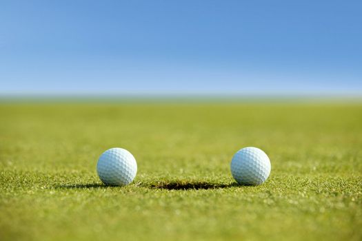 Golf balls near hole