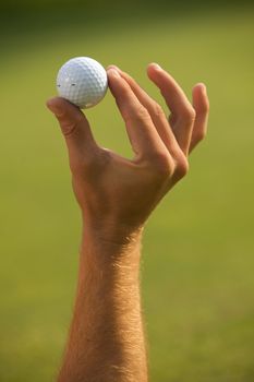 Close-up of human hand holding golf ball
