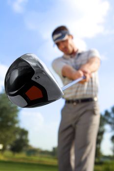 Young man playing golf, low angle view
