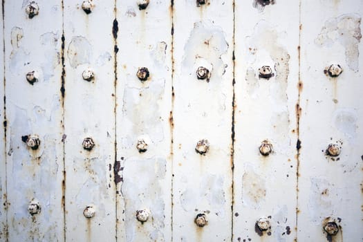 Rusty metal wall with bolts