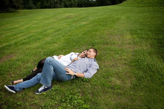 Young couple relaxing on grass