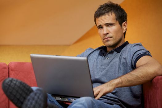 Portrait of young man using laptop