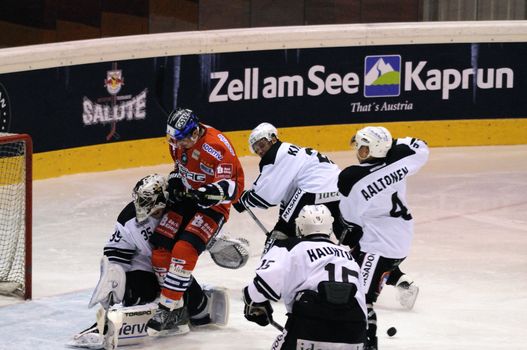 ZELL AM SEE; AUSTRIA - SEPTEMBER 3: Red Bull Salute Tournament. Berlin player runs into Turku goalie Atte Engren.  Game between TPS Turku and Eisbaeren Berlin  (Result 1-4) on September 3, 2010, at the hockey rink of Zell am See