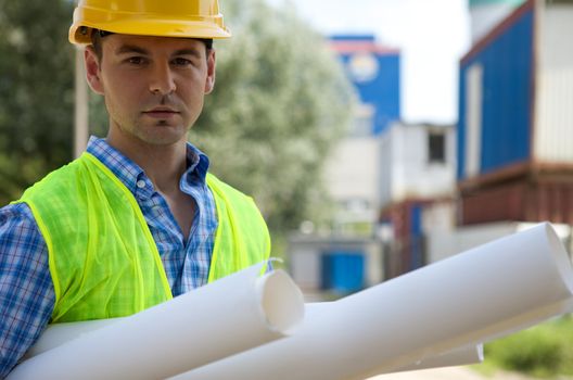 Portrait of architect holding blue prints