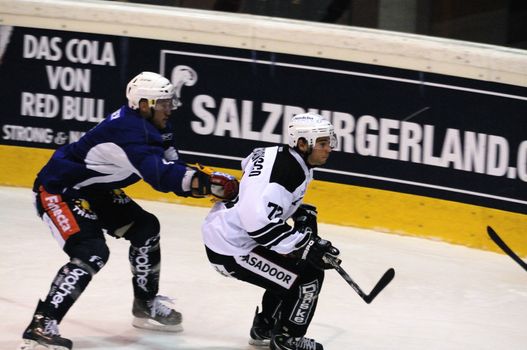 ZELL AM SEE, AUSTRIA - SEPTEMBER 4: Red Bulls Salute Tournament. Mario Valery-Trabucco (Turku)  gets pushed into boards. Game Jokerit Helsinki vs. TPS Turku (Result 8-3) on September 4, 2010 in Zell am See