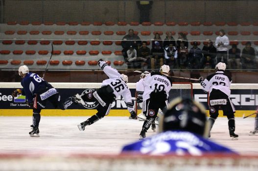 ZELL AM SEE, AUSTRIA - SEPTEMBER 4: Red Bulls Salute Tournament. Joonas Järvinen (36) gets hit by Jokerit player. Game Jokerit Helsinki vs. TPS Turku (Result 8-3) on September 4, 2010 in Zell am See